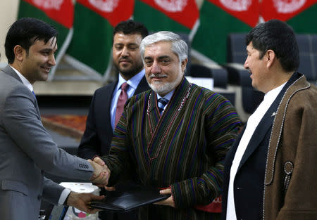 Afghanistan's Chief Executive Abdullah Abdullah, alongside his two vice-presidential candidates Enayatullah Babur Farahmand (L) and Asadullah Saadati (R), arrives to register as a candidate for the upcoming presidential election at the Afghanistan's Independent Election Commission (IEC) in Kabul, Afghanistan January 20, 2019.REUTERS/Omar Sobhani