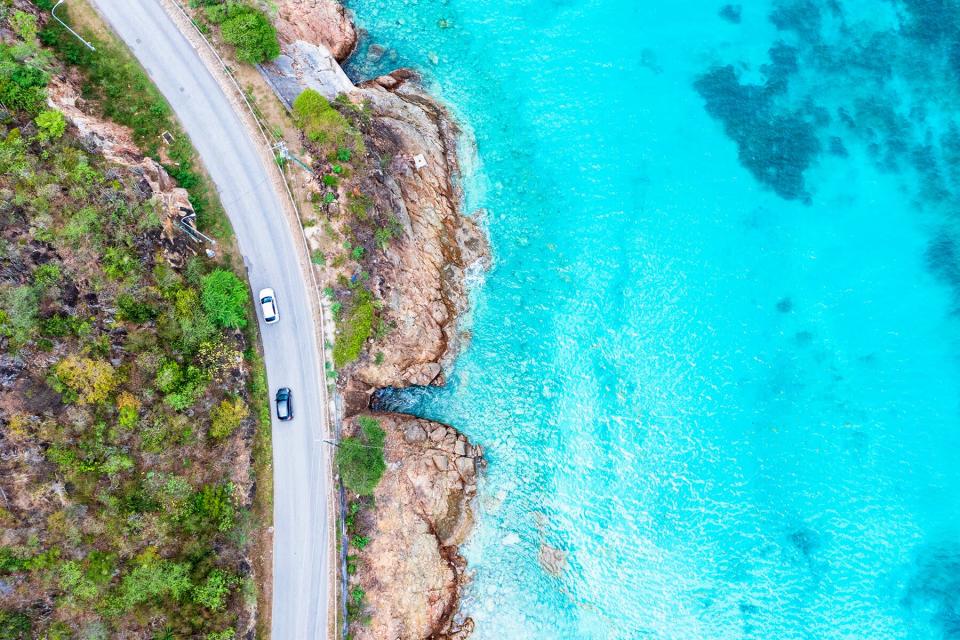 Car traveling on scenic coastal road, Antigua, Caribbean