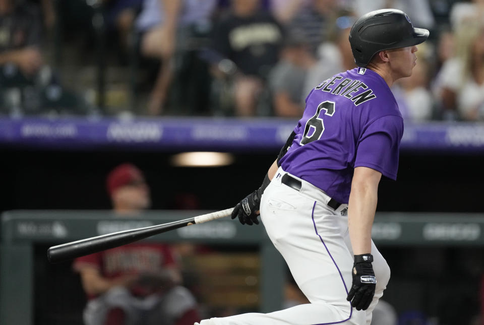 Colorado Rockies' Brian Serven follows the flight of his solo home run off Arizona Diamondbacks starting pitcher Zach Davies in the fifth inning of a baseball game Friday, Aug. 12, 2022, in Denver. (AP Photo/David Zalubowski)