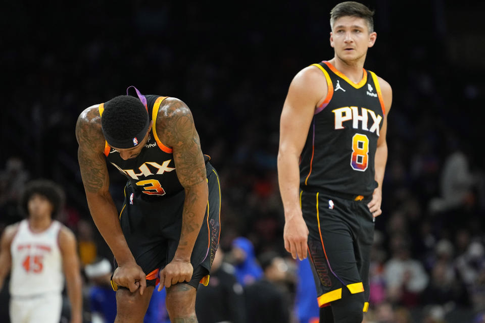 Phoenix Suns guard Bradley Beal (3) looks downward after an injury against the New York Knicks during the first half of an NBA basketball game, Friday, Dec. 15, 2023, in Phoenix. (AP Photo/Matt York)