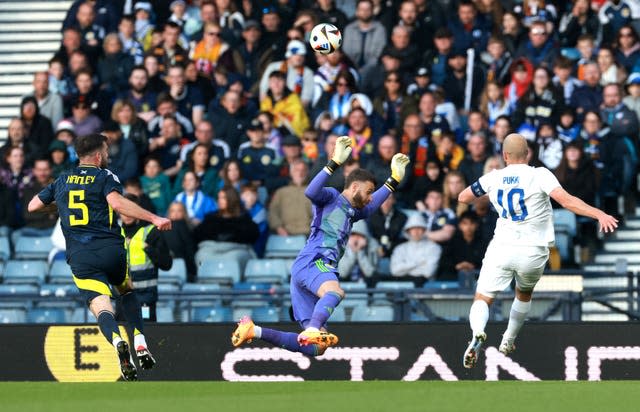 Finland’s Teemu Pukki, right, attempts to chip Scotland goalkeeper Angus Gunn, centre