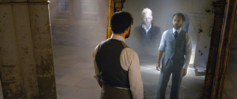 Dumbledore (Jude Law) sees his heart’s desire, Grindelwald (Johnny Depp) reflected in the Mirror of Erised in ‘Fantastic Beasts: The Crimes of Grindelwald’ (Photo: Warner Bros. Entertainment Inc. /Courtesy Everett Collection)