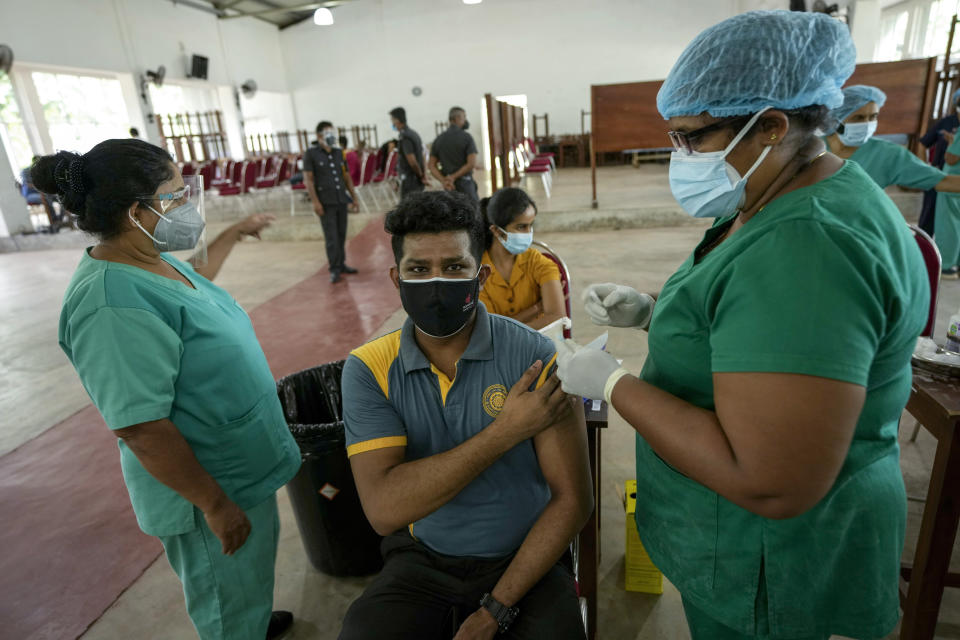 A Sri Lankan university student receives his coronavirus vaccine at the Sri Jayawardenapura university in Colombo, Sri Lanka, Monday, Oct. 11, 2021. (AP Photo/Eranga Jayawardena)