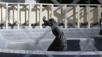 The statue of pioneer woman Laura Ingles is shown behind the fencing put up around the Virginia Women's Memorial on Capitol Square in Richmond, Va., Friday, Jan. 17, 2020. The fencing was to protect the monuments from the large crowd expected for the pro-gun rally Monday, Jan. 20. (Bob Brown/Richmond Times-Dispatch via AP)