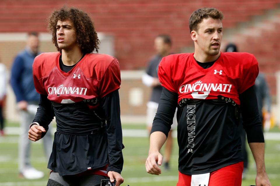 Cincinnati Bearcats quarterbacks Evan Prater (3) and Ben Bryant (6) finish a session during a spring practice at Nippert Stadium in Cincinnati on Thursday, March 24, 2022.