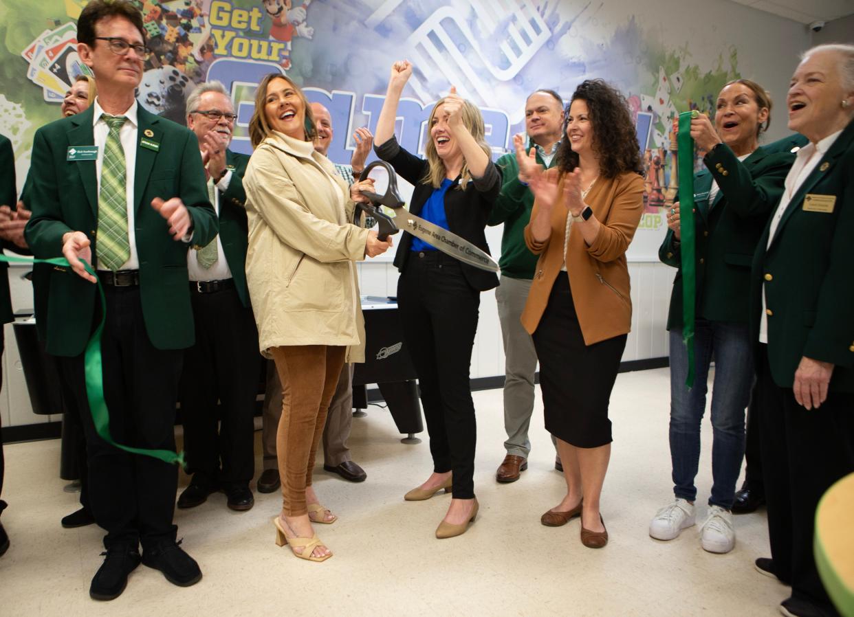 Officials and supporters including board President Amy Newport, center left, and Executive Director Shelly Williams celebrate the reopening of the Boys and Girls Club of Emerald Valley at Westmorland Park in Eugene during a ceremony on Wednesday.