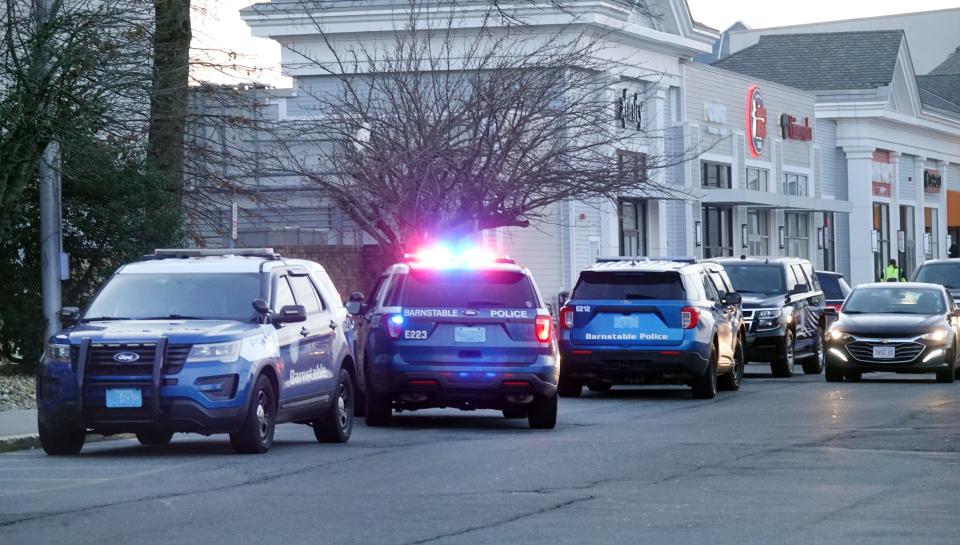 Five police cars were parked in front of Macy's department store at the Cape Cod Mall Monday as Barnstable police investigated a stabbing.