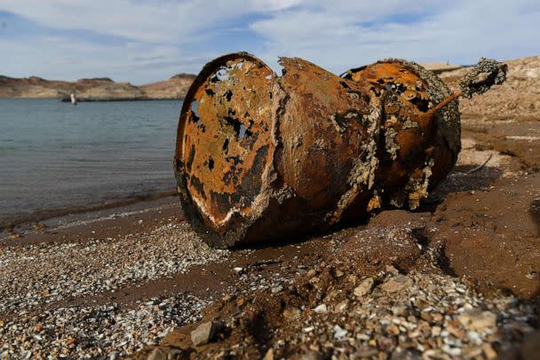 PHOTO: A rusted metal barrel, near the location of where a different barrel was found containing  a human body, sits exposed during low water levels due to drought at the Lake Mead Marina on the Colorado River in Boulder City, Nev., May 5, 2022. (Patrick T. Fallon/AFP via Getty Images)