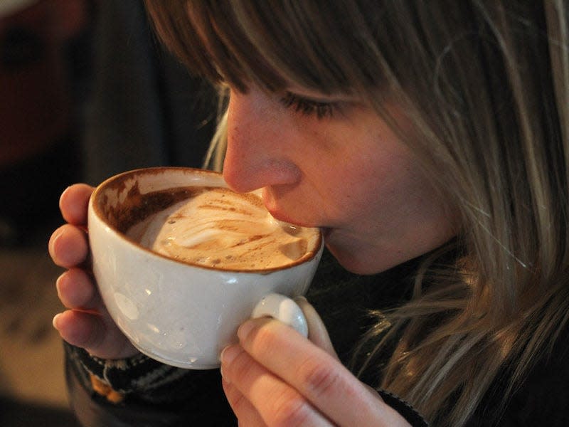 woman drinking cup of coffee