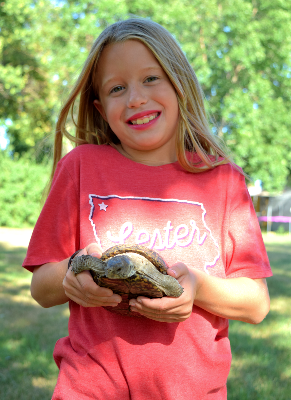 Charis Knobloch of El Paso, Texas poses for a photo with her pet desert box turtle named Scoot