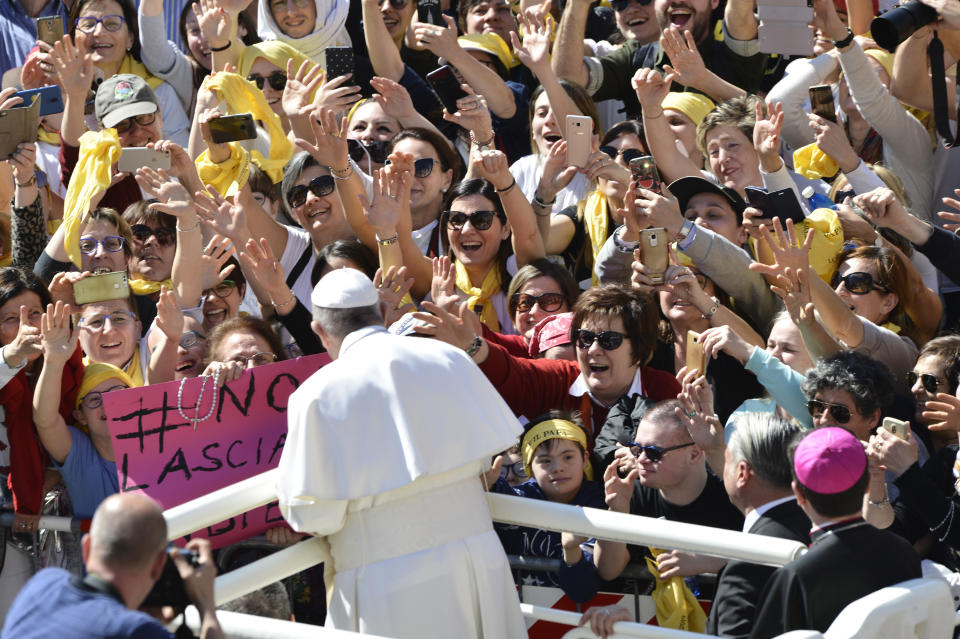 Faithful wave and reach out to Pope Francis upon his arrival at Loreto's cathedral, central Italy, Monday, March 25, 2019. Francis has traveled to a major Italian pilgrimage site dedicated to the Virgin Mary to sign a new document dedicated to today's youth. (AP Photo/Sandro Perozzi)