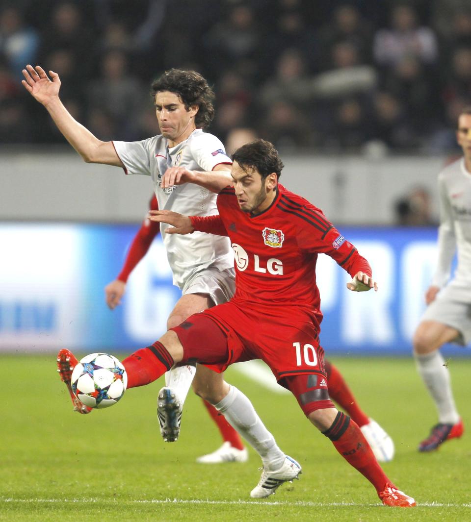 Bayer Leverkusen's Hakan Calhanoglu challenges Atletico Madrid's Tiago Mendes (L) during their Champions League round of 16, first leg soccer match in Leverkusen February 25, 2015. REUTERS/Ina Fassbender (GERMANY - Tags: SPORT SOCCER)