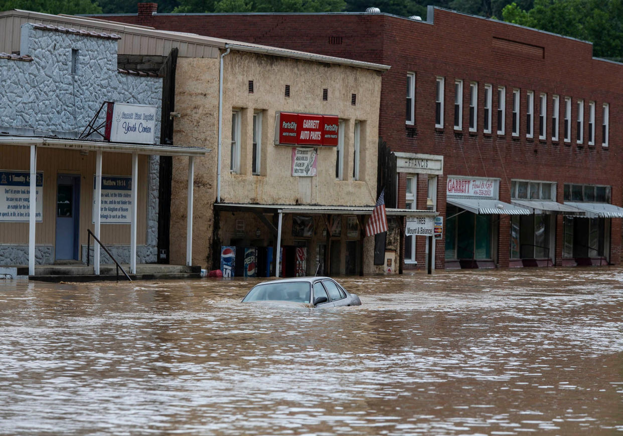 A car is submerged in floodwaters along Right Beaver Creek in Garrett, Ky., on Thursday. 