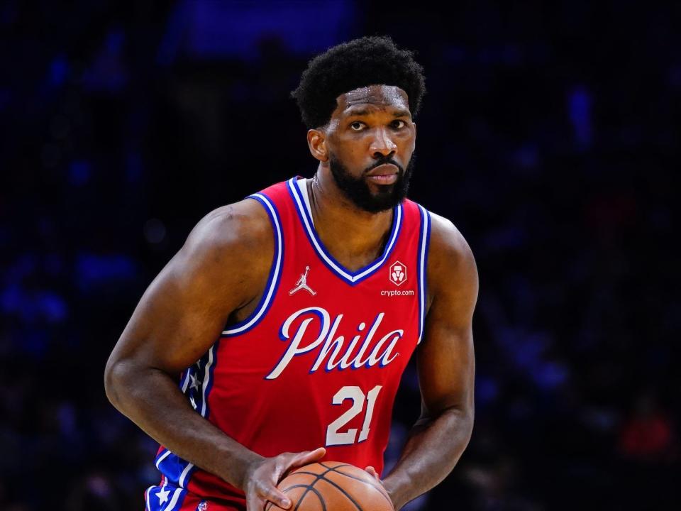 Joel Embiid holds the ball during a game.