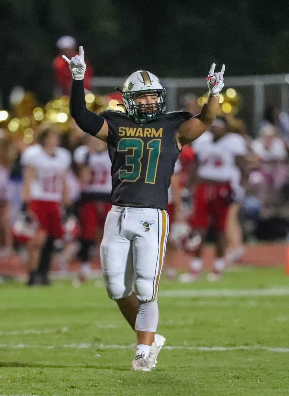 Savannah Country Day linebacker Sam Bueno motions with his hands as signs come in from the coaches during a recent game against Savannah Christian.