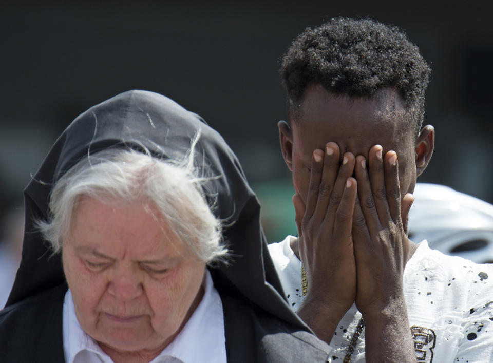 <p>People mourn beside the Olympia shopping center where a shooting took place leaving nine people dead two days ago in Munich, Germany, July 24, 2016. (Photo: Jens Meyer/AP)</p>