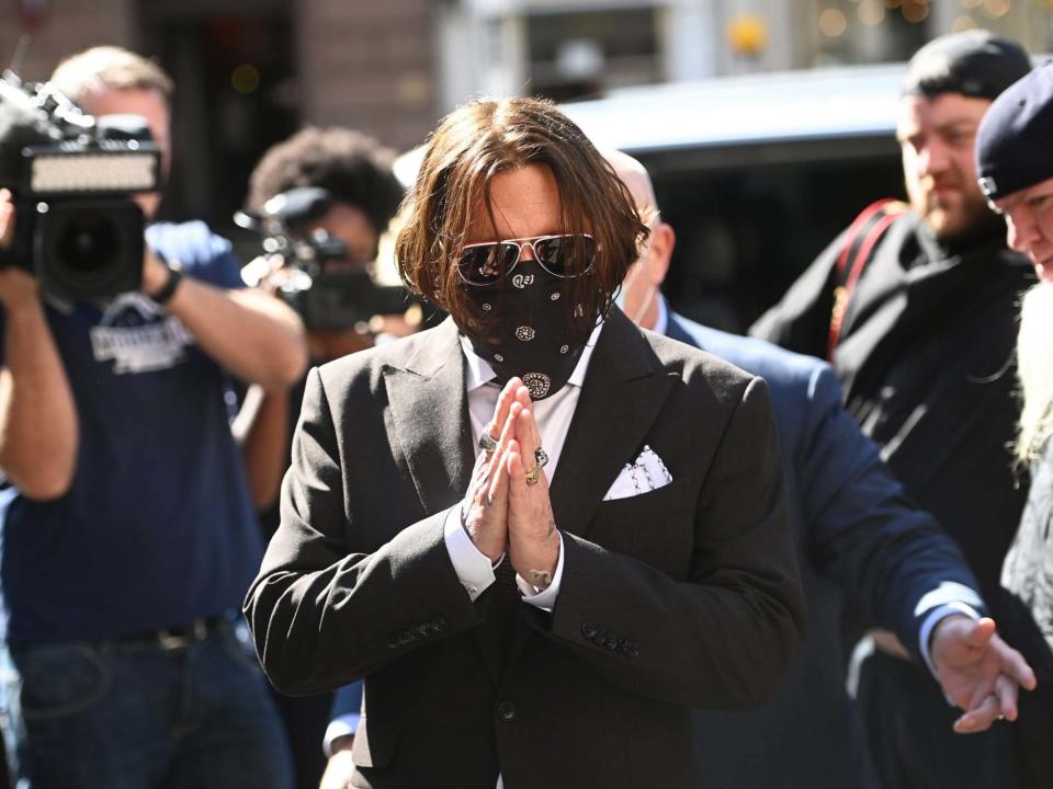 Johnny Depp, wearing a face mask, arrives at the Royal Courts of Justice in London: EPA