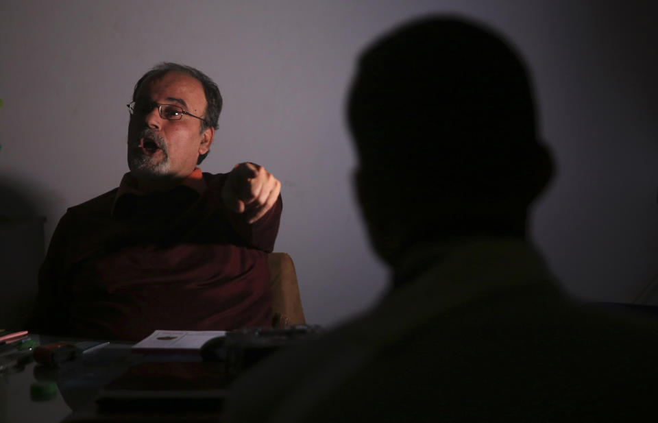 In this Sunday, Feb. 10, 2019 photo, Dr. Fadel Ashour, a psychiatrist, neurologist and professor at the medical school at Gaza’s al-Azhar University, explains to painkiller abuser Mahmoud, 29, what will happen to him if he continue taking the pills, during an addiction treatment session, at his clinic in Gaza City. An opioid crisis has quietly spread in the Gaza Strip, trapping thousands of people in the hell of addiction and adding another layer of misery to the blockaded and impoverished coastal territory. (AP Photo/Adel Hana)