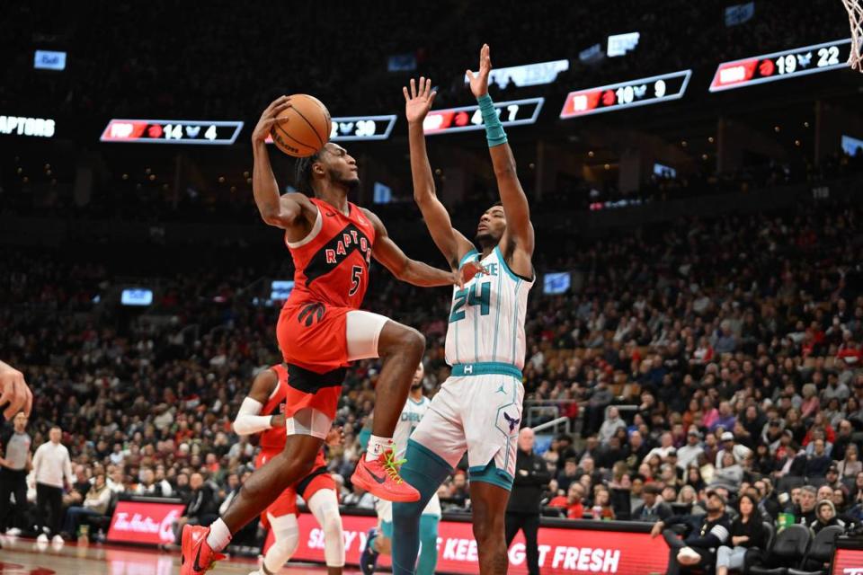 Toronto Raptors guard Immanuel Quickley (5) drives to the basket against Charlotte Hornets forward Brandon Miller (24) in the first half at Scotiabank Arena.