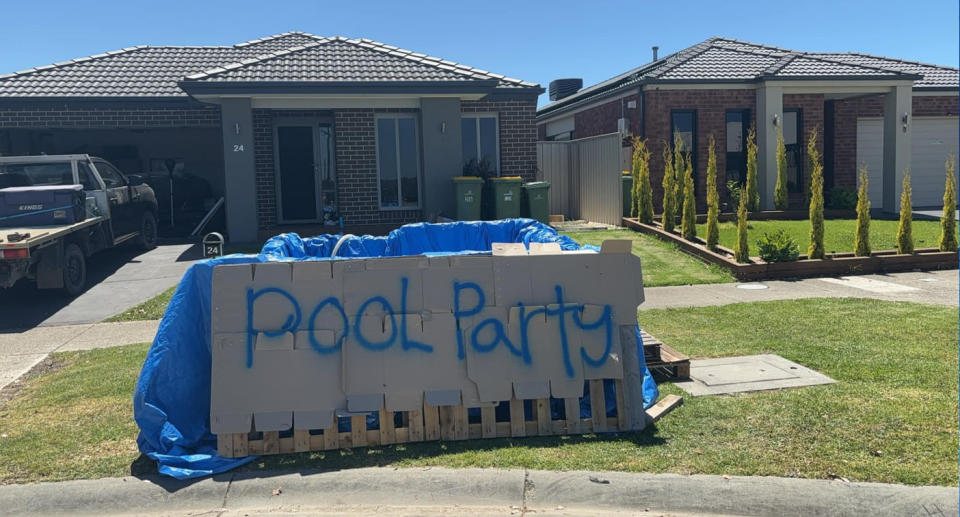 Makeshift pool in Melbourne front yard with a sign that says 'pool party'. 