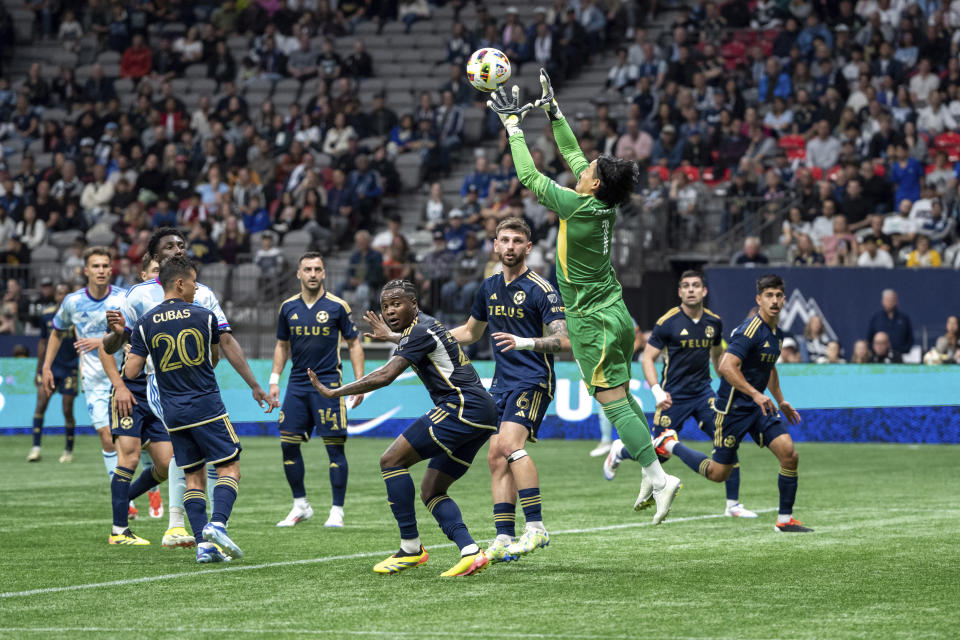 Vancouver Whitecaps goalkeeper Yohei Takaoka (1) jumps for the ball during the first half of the team's MLS soccer match against the Colorado Rapids on Saturday, June 1, 2024, in Vancouver, British Columbia. (Ethan Cairns/The Canadian Press via AP)