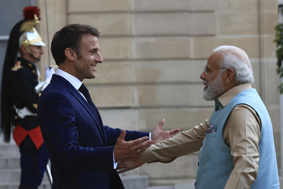 French President Emmanuel Macron welcomes Indian Prime Minister Narendra Modi before a working dinner, Thursday, July 13, 2023 at the Elysee Palace, in Paris. Narendra Modi is on a two-day visit and will attend Bastille Day parade with French President Emmanuel Macron on Friday. (AP Photo/Aurelien Morissard)