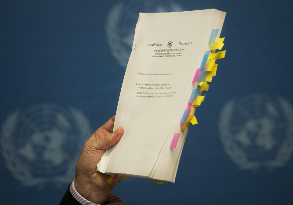 Retired Australian judge Michael Kirby, chairperson of the commission of Inquiry on Human Rights in the Democratic People's Republic of Korea, shows the commission's report during a press conference at the United Nations in Geneva, Switzerland, Monday, Feb. 17, 2014. A U.N. panel has warned North Korean leader Kim Jong Un that he may be held accountable for orchestrating widespread crimes against civilians in the secretive Asian nation. Kirby told the leader in a letter accompanying a yearlong investigative report on North Korea that international prosecution is needed "to render accountable all those, including possibly yourself, who may be responsible for crimes against humanity." (AP Photo/Anja Niedringhaus)