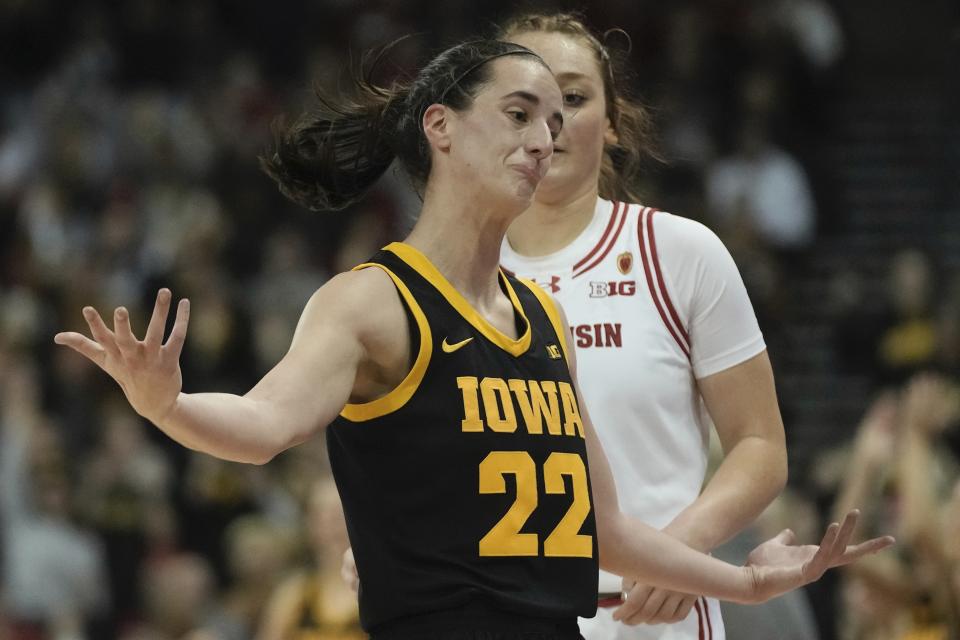 Iowa's Caitlin Clark reacts after her three pointer during the first half of a women's NCAA college basketball game Sunday, Dec. 10, 2023, in Madison, Wis. (AP Photo/Morry Gash)