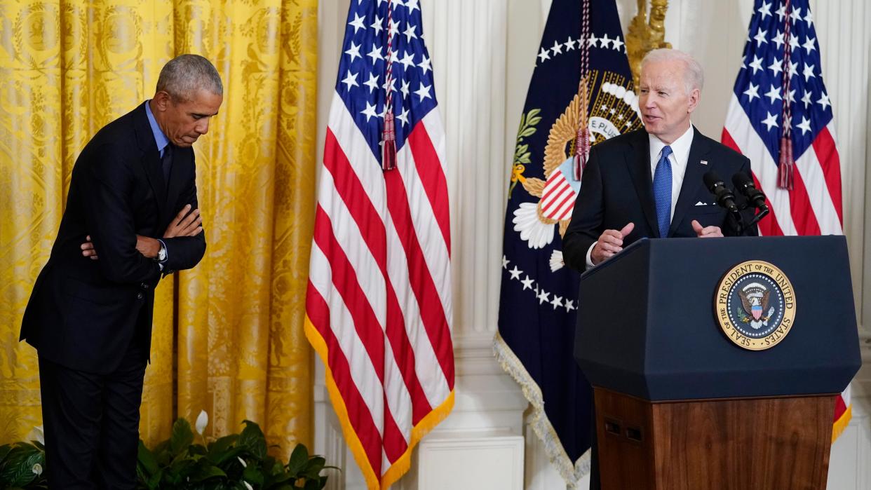 Former President Barack Obama bows in acknowledgment of President Joe Biden as he speaks during an event about the Affordable Care Act in the East Room of the White House in Washington on Tuesday, April 5, 2022.