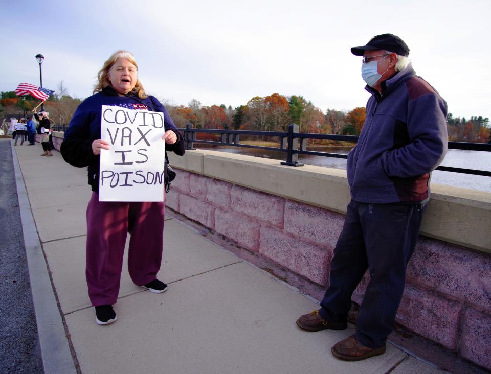 Wed., Nov. 17, 2021 -- Lori Mason of Brockton, and Michael Ursini of Dighton, engage in a vigorous discussion atop the Berkley-Dighton Bridge. Mason is anti-mask and vaccination, Ursini is for them. Ursini made a special trip down to talk with Mason and her fellow protesters, and the discussions were cordial and respectful.