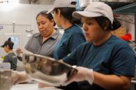 Workers prepare orders in the kitchen at the newest Chopt Creative Salad Co., location in New York