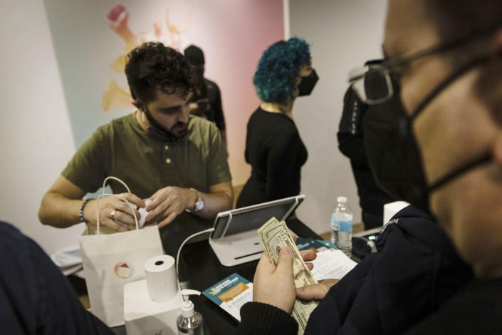 A cashier puts cannabis products into a bag at the Housing Works Cannabis Co., New York's first legal cannabis dispensary at 750 Broadway in Noho on Thursday, Dec. 29, 2022, in New York. (AP Photo/Stefan Jeremiah)