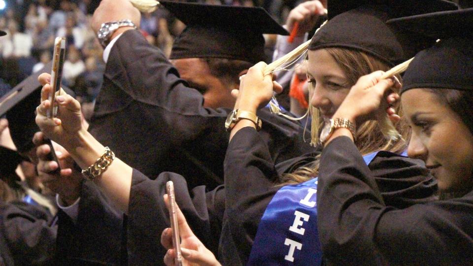 Embry-Riddle Aeronautical University students slide their tassels, symbolizing the completion of their degrees.