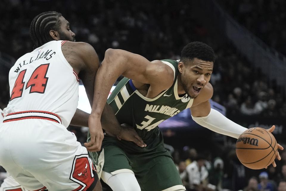 Milwaukee Bucks' Giannis Antetokounmpo tries to get past Chicago Bulls' Patrick Williams during the first half of an NBA game Monday, Dec. 11, 2023, in Milwaukee. (AP Photo/Morry Gash)