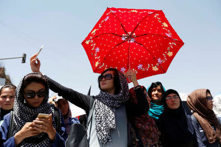 A woman from Afghanistan's Hazara minority take sefie as she attends a protest in Kabul, Afghanistan July 23, 2016. REUTERS/Mohammad Ismail