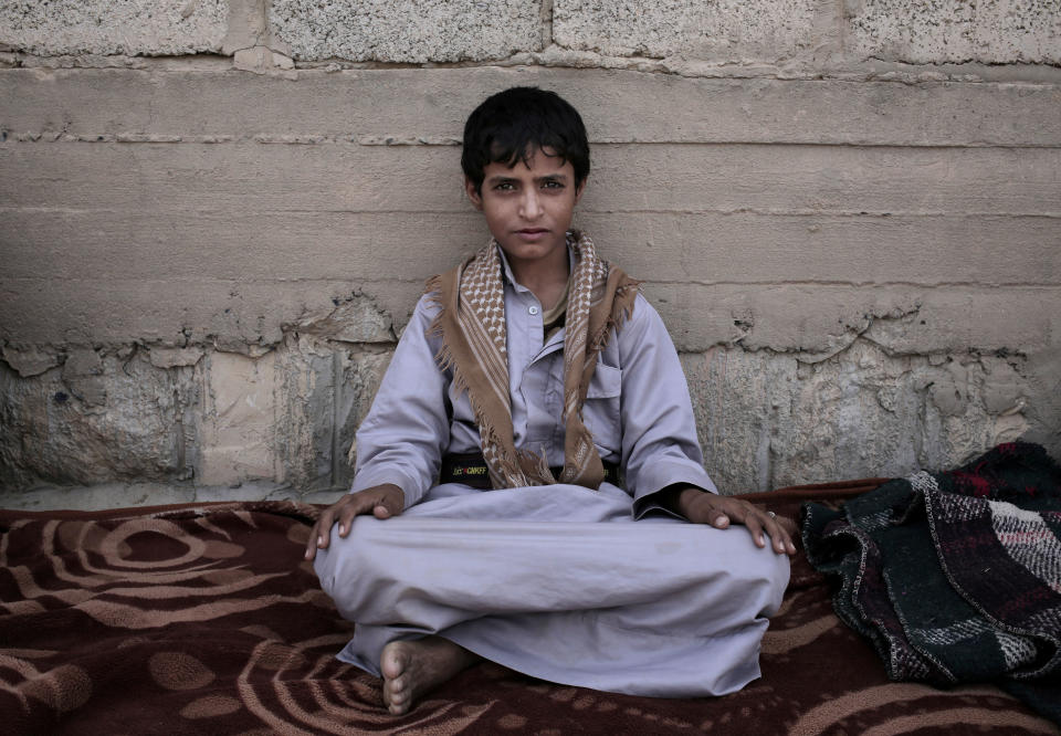 Abdel-Hamid, a 14-year-old former child soldier, poses for a photograph at a camp for displaced persons where he took shelter, in Marib, Yemen, in this July 27, 2018, photo. Tasked by Houthi rebel to carry supplies to other fighters in the high mountains, he says he saw children get shot for not obeying orders. He said the front-lines are full of children. (AP Photo/Nariman El-Mofty)