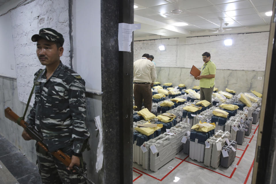 An Indian paramilitary soldier stands guard outside a room where voting machines are stored as counting of votes in India's massive general elections begins in New Delhi, India, Thursday, May 23, 2019. The count is expected to conclude by the evening, with strong trends visible by midday. (AP Photo/Manish Swarup)