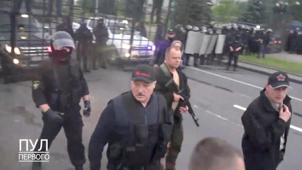 Belarusian President Alexander Lukashenko walks outside the Independence Palace after an opposition demonstration against presidential election results, in Minsk, Belarus, in this still image from a handout video taken Sunday, August 23, 2020. / Credit: Pool Pervogo / Handout via Reuters TV