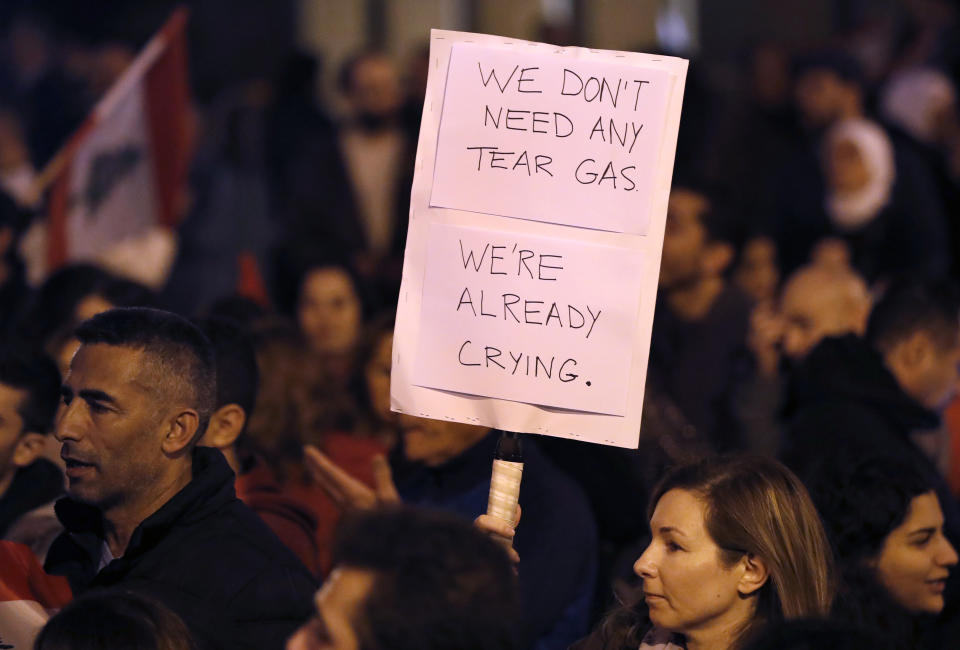 Anti-government protesters gather near the parliament square, in downtown Beirut, Lebanon, Sunday, Dec. 15, 2019. Lebanese security forces fired tear gas, rubber bullets and water cannons Sunday to disperse hundreds of protesters for a second straight day, ending what started as a peaceful rally in defiance of the toughest crackdown on anti-government demonstrations in two months. (AP Photo/Hussein Malla)