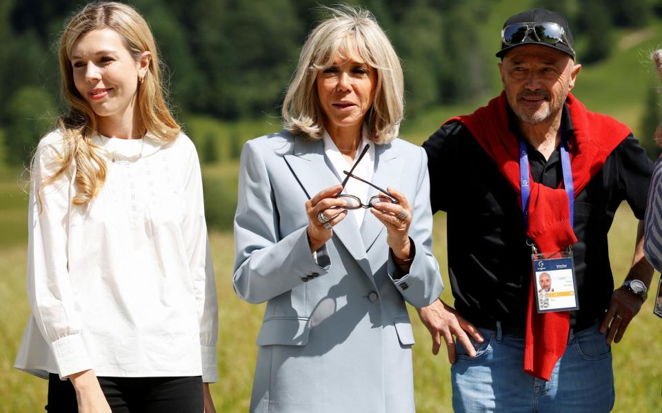 Carrie Johnson and Brigitte Macron look on during a demonstration of summer training technique for cross-country skiing as they attend the G7 summit in southern Germany - Michaela Rehle/Reuters