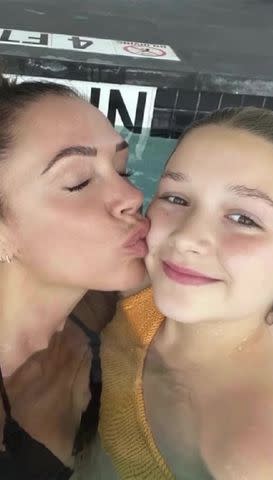 <p>David Beckham/Instagram</p> Victoria Beckham kisses daughter Harper