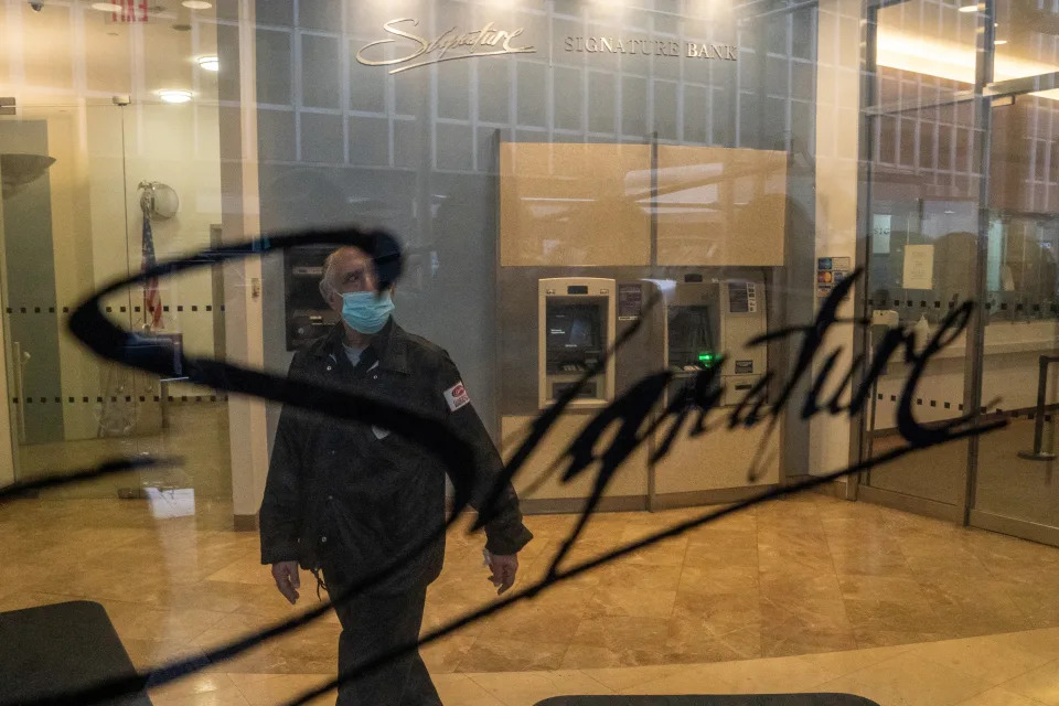 A security guard walks in the ATM lobby of a Signature Bank branch in New York City, U.S., March 13, 2023. REUTERS/David 'Dee' Delgado