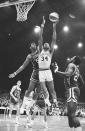 FILE - Gene Moore of the Kentucky Colonels, left, tries to stop Mel Daniels (34) of the Indiana Pacers during an American Basketball Association playoff game in Indianapolis, April 9, 1969. The ABA developed some true stars of the game, including Calvin, Julius Erving, Artis Gilmore and George Gervin, but it's largely remembered for paltry crowds, shaky finances and a red, white and blue ball. (AP Photo/File)