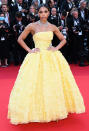 <p>brings the sunshine in a canary-yellow strapless ruffled ballgown with sparkling jewels by Messika. </p>