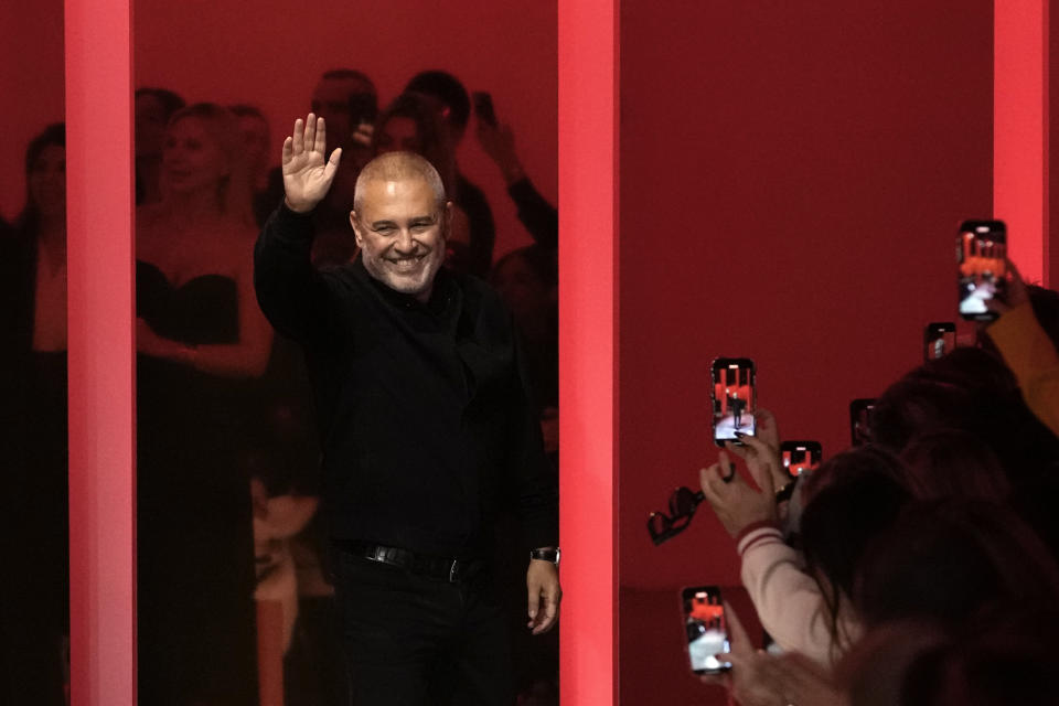 Designer Elie Saab waves after his Haute Couture Spring-Summer 2024 collection presented in Paris, Wednesday, Jan. 24, 2024. (AP Photo/Christophe Ena)