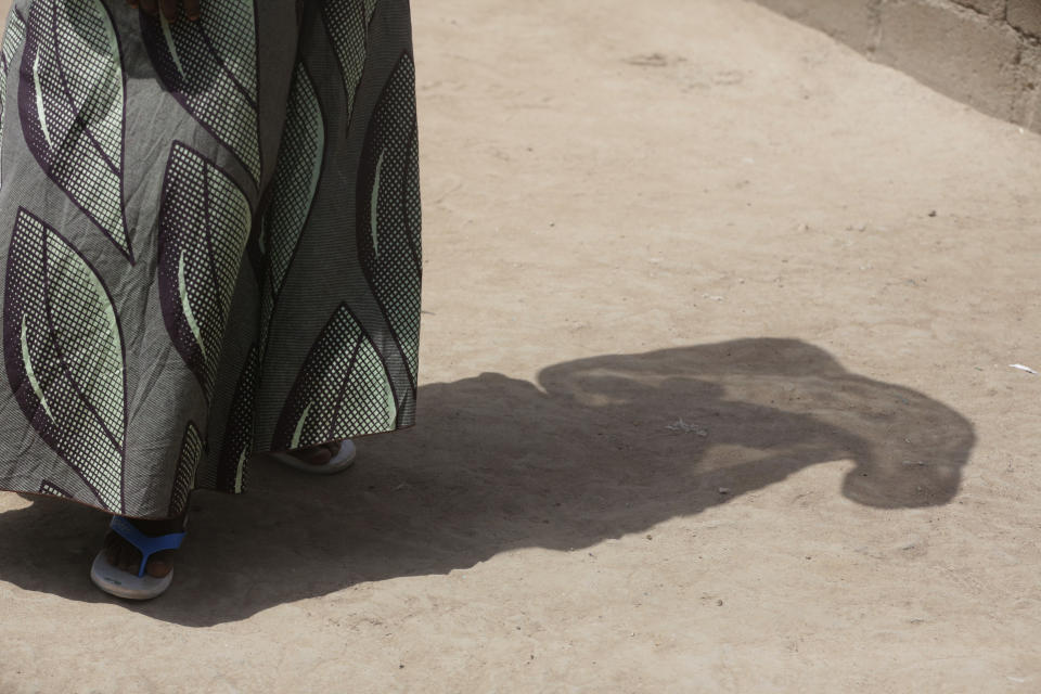 In this photo taken on Tuesday, Feb. 19, 2019, Maria Saleh a woman who says she was assaulted and displaced by Islamist extremist is photographed at Malkohi camp in Yola, Nigeria. Maria is from the town of Madagali in Adamawa, has a child by a Boko Haram fighter who assaulted and then enslaved her for months following a 2014 attack that killed her husband. Two of her children were taken by militants. (AP Photo/ Sunday Alamba)