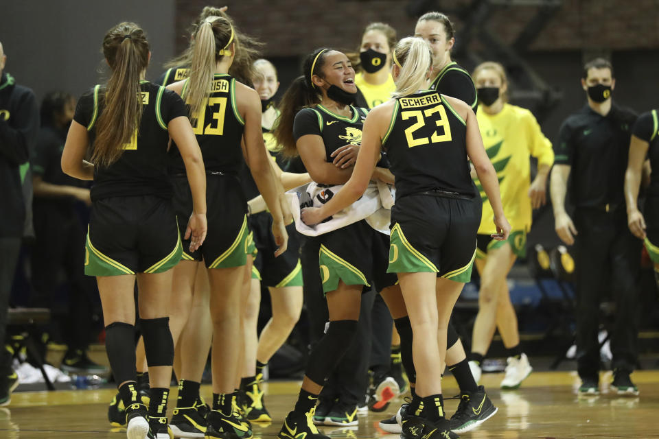 Members of the Oregon bench celebrate a basket against Stanford during the first half of an NCAA college basketball game in Santa Cruz, Calif., Friday, Jan. 8, 2021. (AP Photo/Jed Jacobsohn)