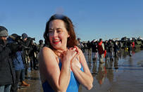 <p>Polar Bear Club swimmers make their annual icy plunge into the Atlantic Ocean on New Year’s Day, January 1, 2018, at Coney Island in the Brooklyn borough of New York City. (Photo: Yana Paskova/Getty Images) </p>