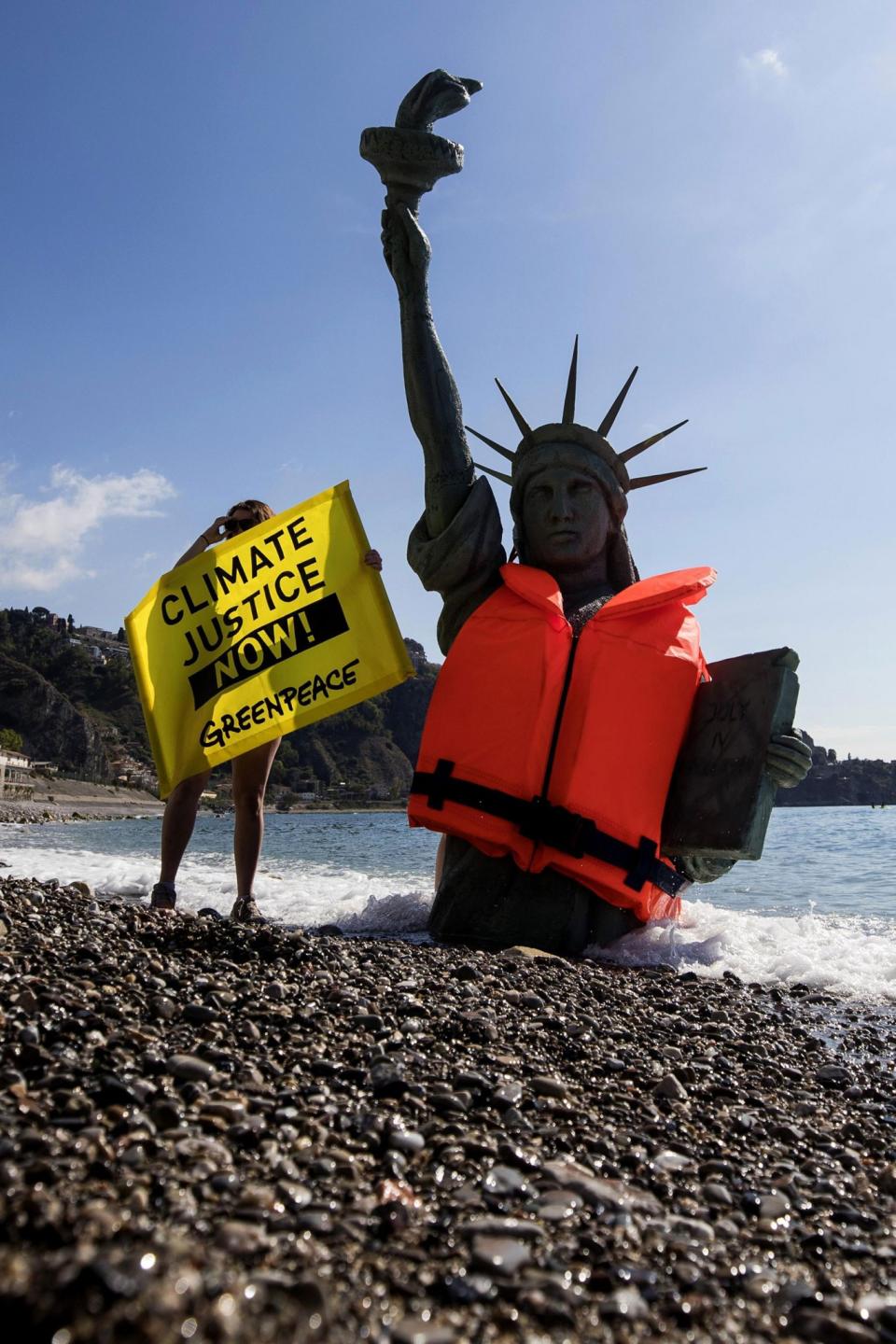 <p>Greenpeace activists stage a demonstration in Giardini Naxos, near the venue of the G7 summit in the Sicilian town of Taormina, southern Italy, Friday, May 26, 2017. Climate change promises to be the most problematic issue for this summit after Trump’s decision to review U.S. policies related to the Paris Agreement on fighting global warming. (Angelo Carconi/ANSA via AP) </p>