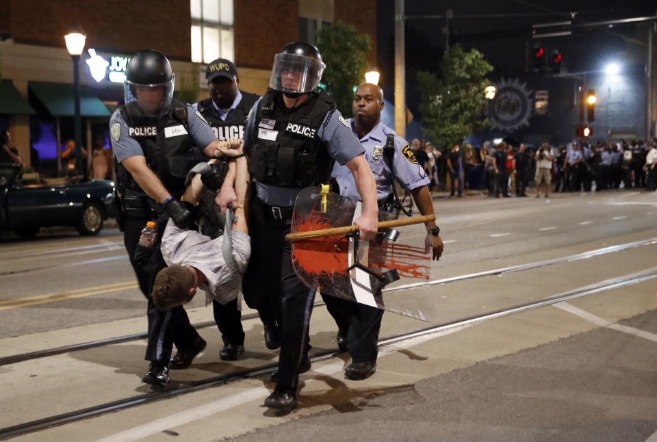 <p>Police arrest a man as they try to clear a violent crowd Saturday, Sept. 16, 2017, in University City, Mo. Earlier, protesters marched peacefully in response to a not guilty verdict in the trial of former St. Louis police officer Jason Stockley. (Photo: Jeff Roberson/AP) </p>